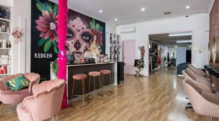 Vibrant interior of M.O.H & Co in Melbourne, Victoria, AU showcasing colorful wall art and chic seating.