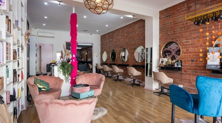 Cozy salon interior at M.O.H & Co, Melbourne, Victoria, AU featuring chic pink seating and elegant decor.