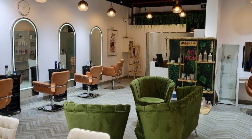 Modern interior of Zenesty Beauty Lounge in Dubai, AE, showcasing plush seating and elegant styling stations.