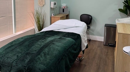 Treatment room at NU Med Clinic and MediSpa in Toronto, Ontario, CA with a calming green bed.