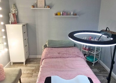 Cozy treatment room at Minutiae Beauty, Cape Town, Western Cape, ZA with plush bed and vibrant lighting.