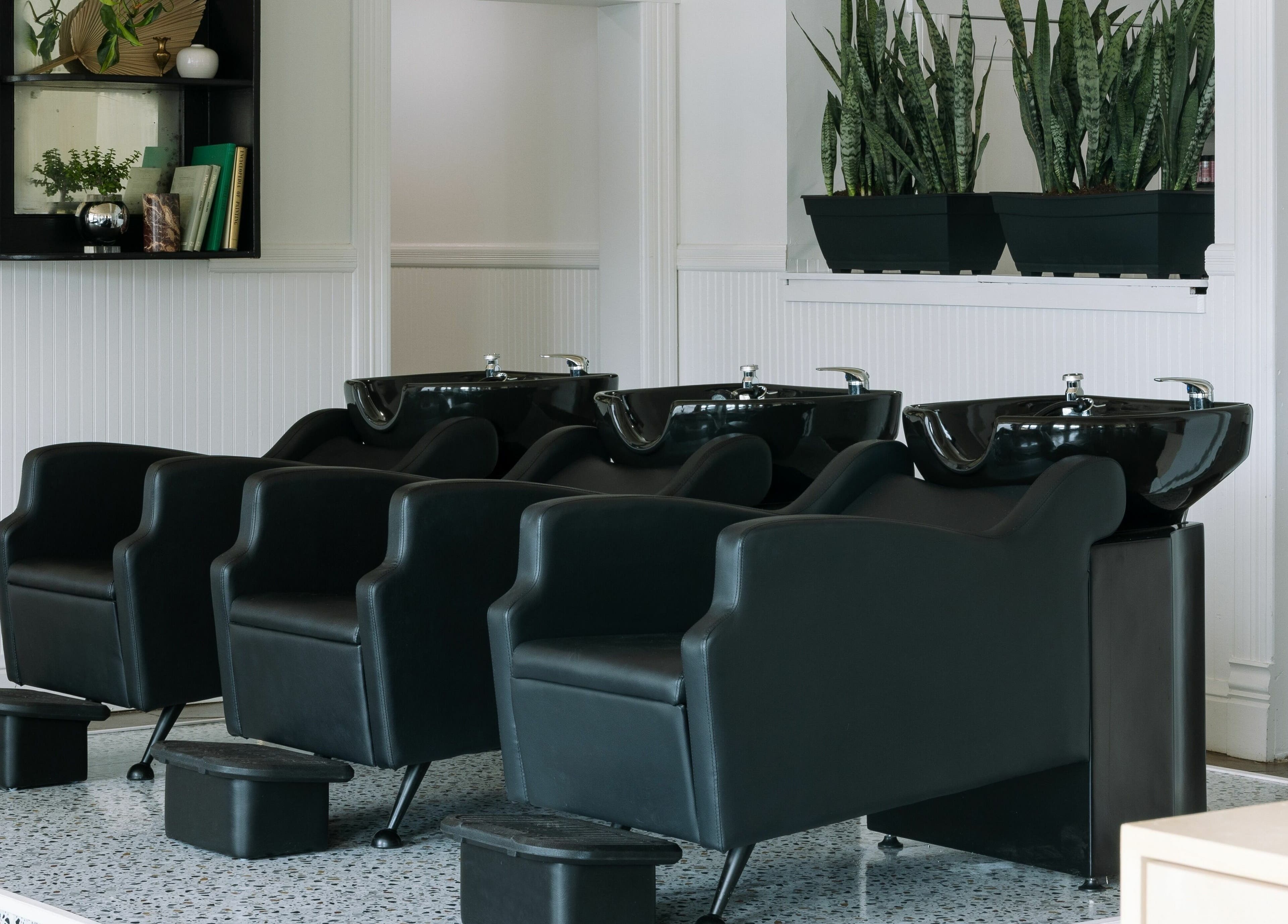 Elegant hair wash stations at MATERIAL - Tampa in Tampa, Florida, US, showcasing modern salon design.