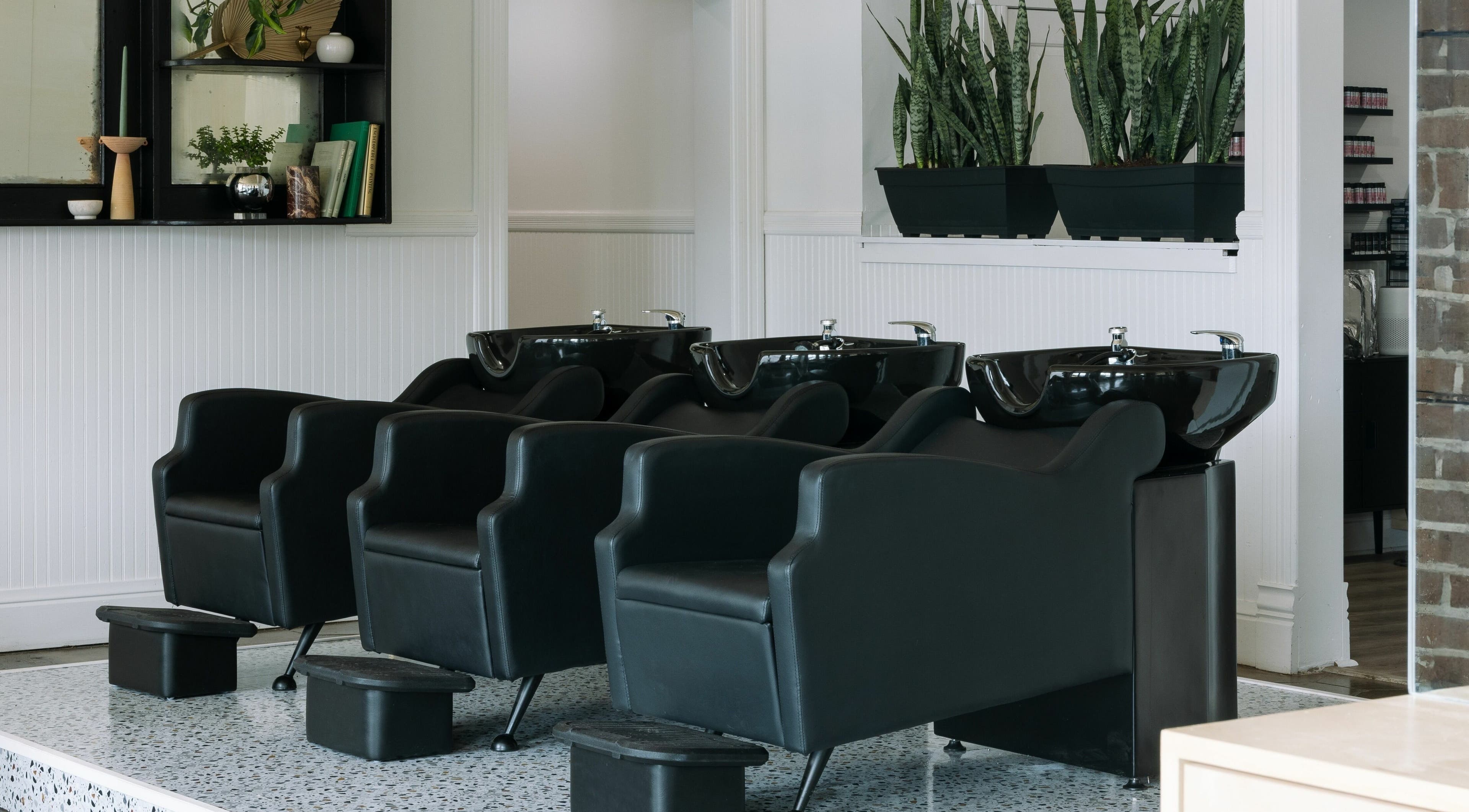 Elegant hair wash stations at MATERIAL - Tampa in Tampa, Florida, US, showcasing modern salon design.