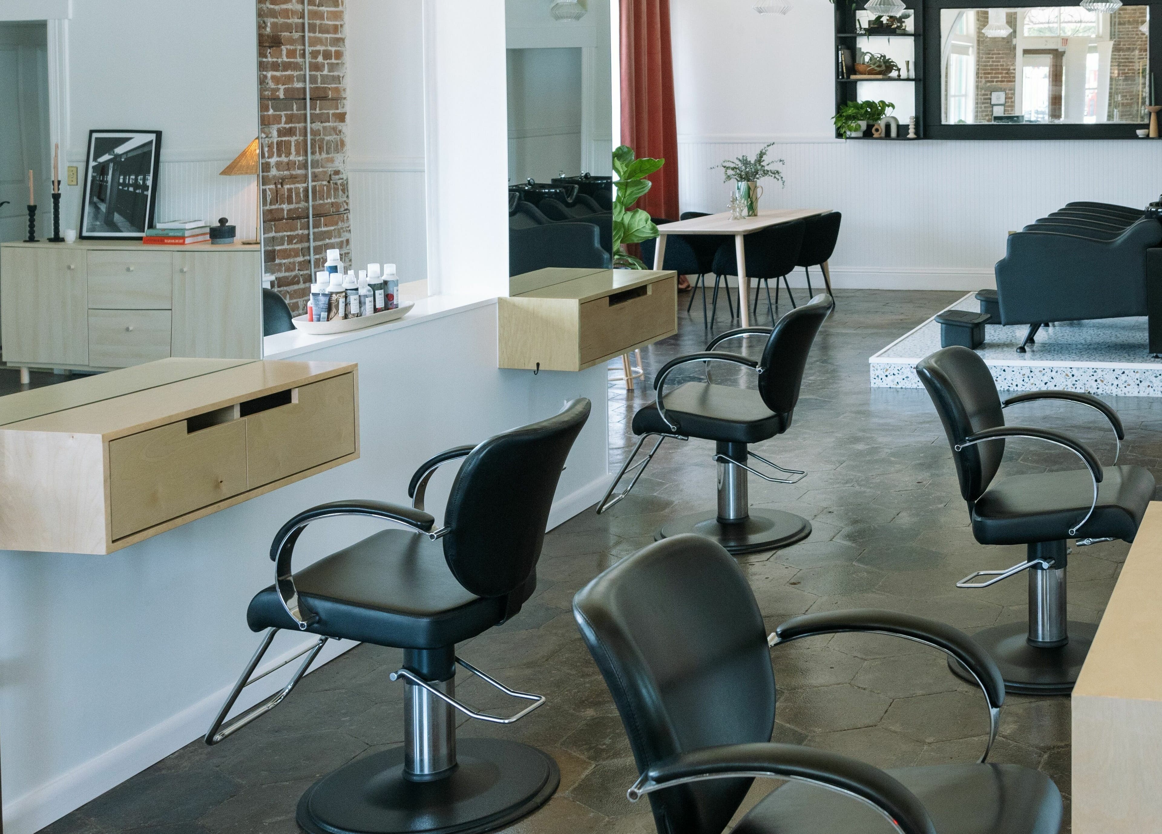 Modern salon interior at MATERIAL - Tampa, featuring sleek styling chairs in Tampa, Florida, US.