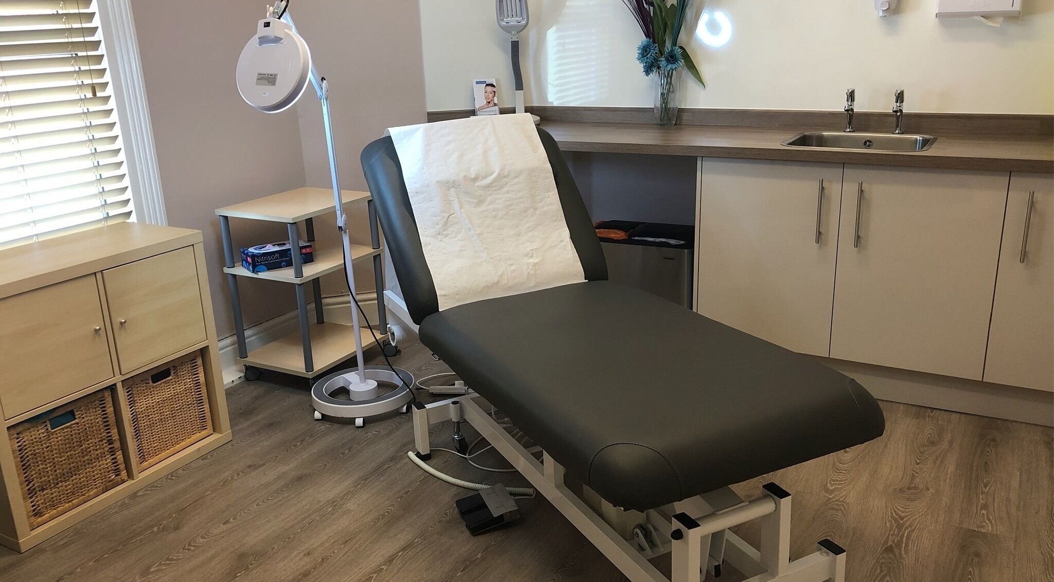 Elegant treatment room at Cheshire Lasers Clinic, Middlewich, England, GB, featuring a comfortable therapy bed.