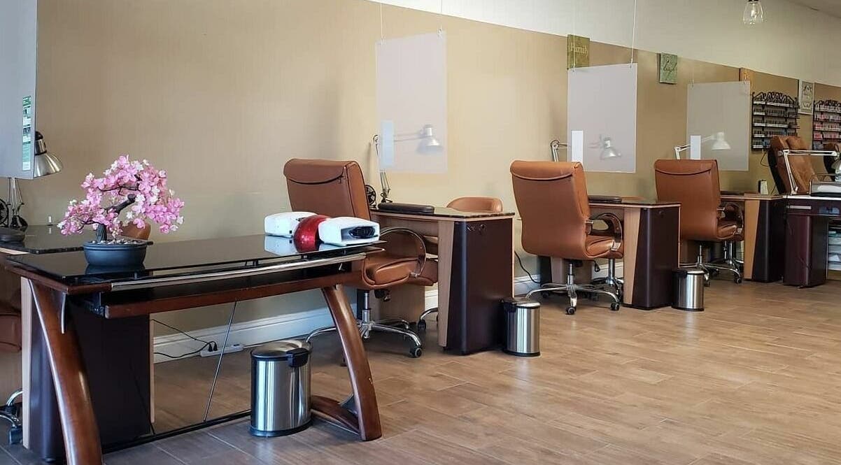 Spacious nail station at Chic Hair & Nails, Fresno, California, US, featuring modern chairs and vibrant decor.