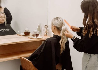 Stylist creating a chic ponytail at Melt Salon Collective, Nelson Bay, New South Wales, AU.