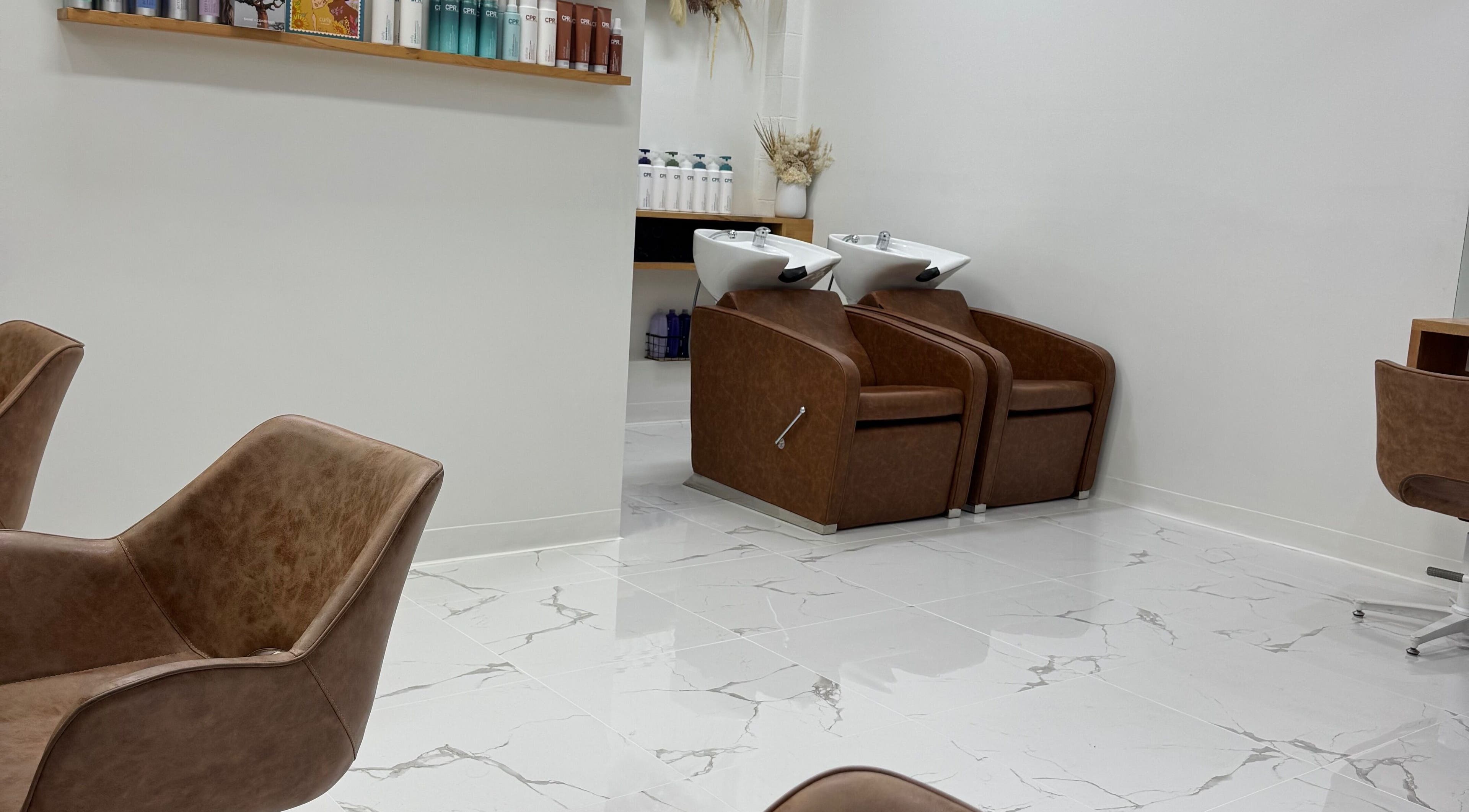 Modern rinse stations at Melt Salon Collective, Nelson Bay, New South Wales, AU showcasing sleek, stylish chairs.