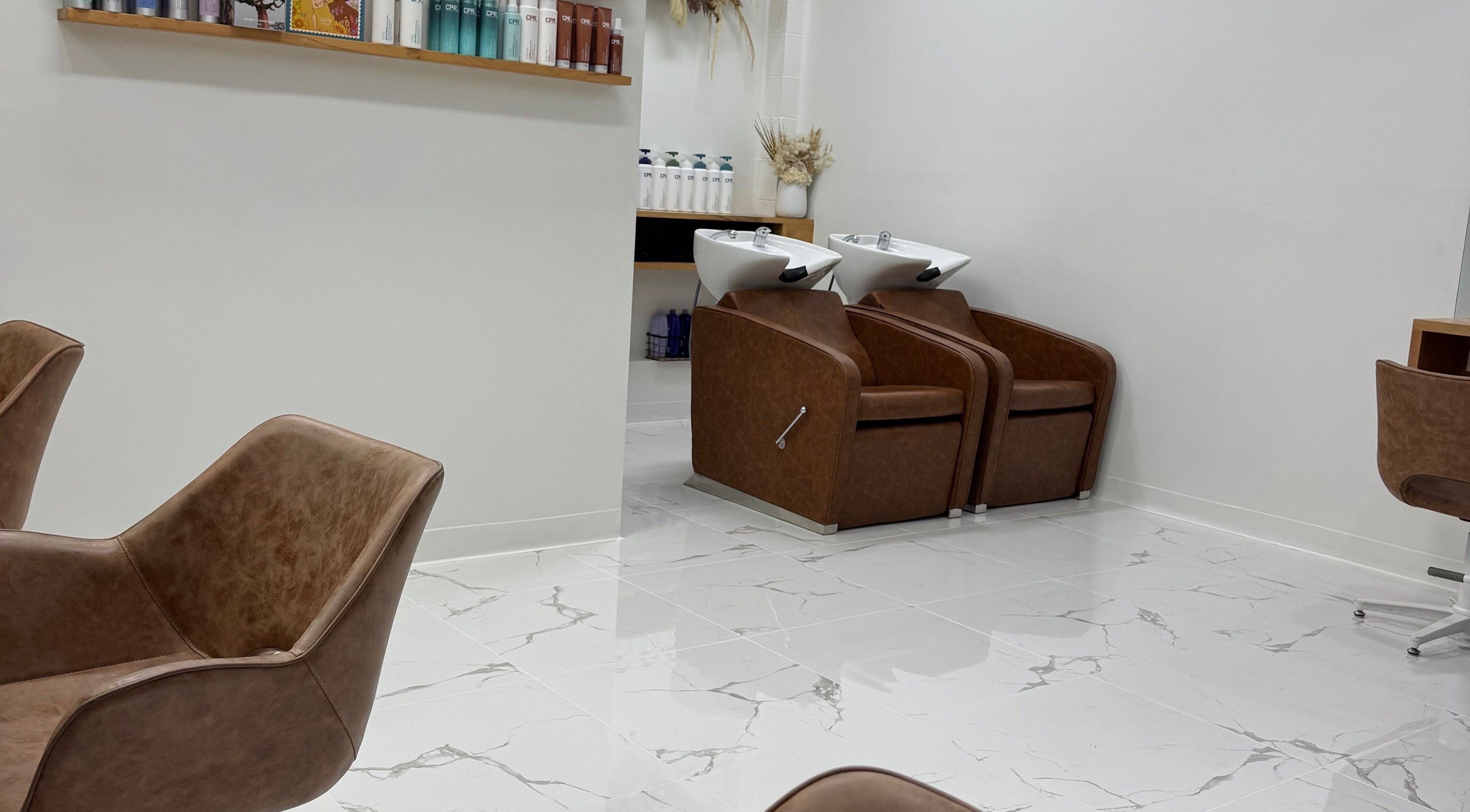 Modern rinse stations at Melt Salon Collective, Nelson Bay, New South Wales, AU showcasing sleek, stylish chairs.