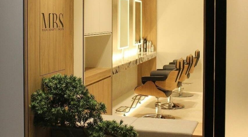 Chic interior of MBS Mila Beauty Salon in Dubai, AE showcasing modern chairs and decor.