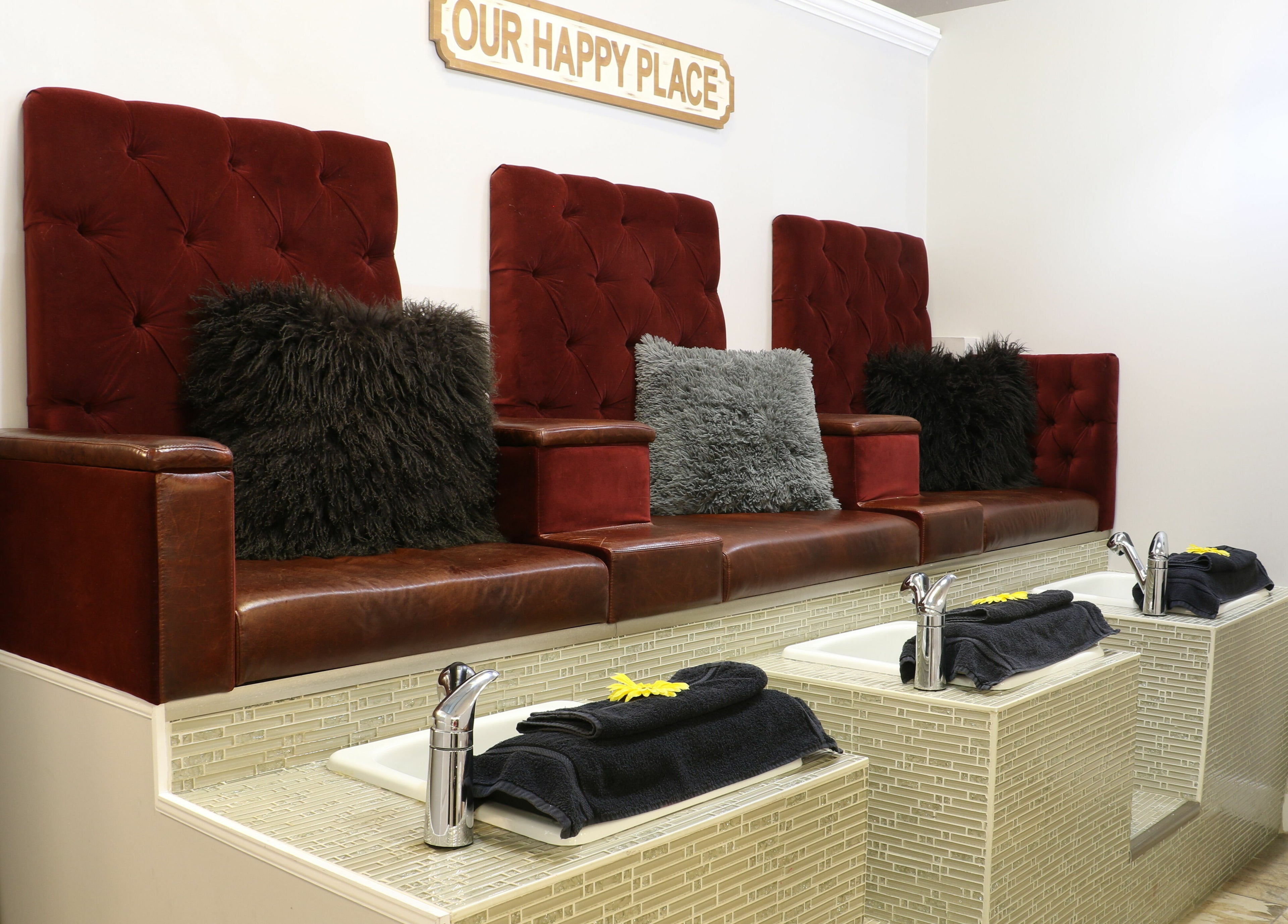 Luxurious pedicure seating at Boulevard Salon and Esthetics, Surrey, British Columbia, CA, with rich red upholstery.