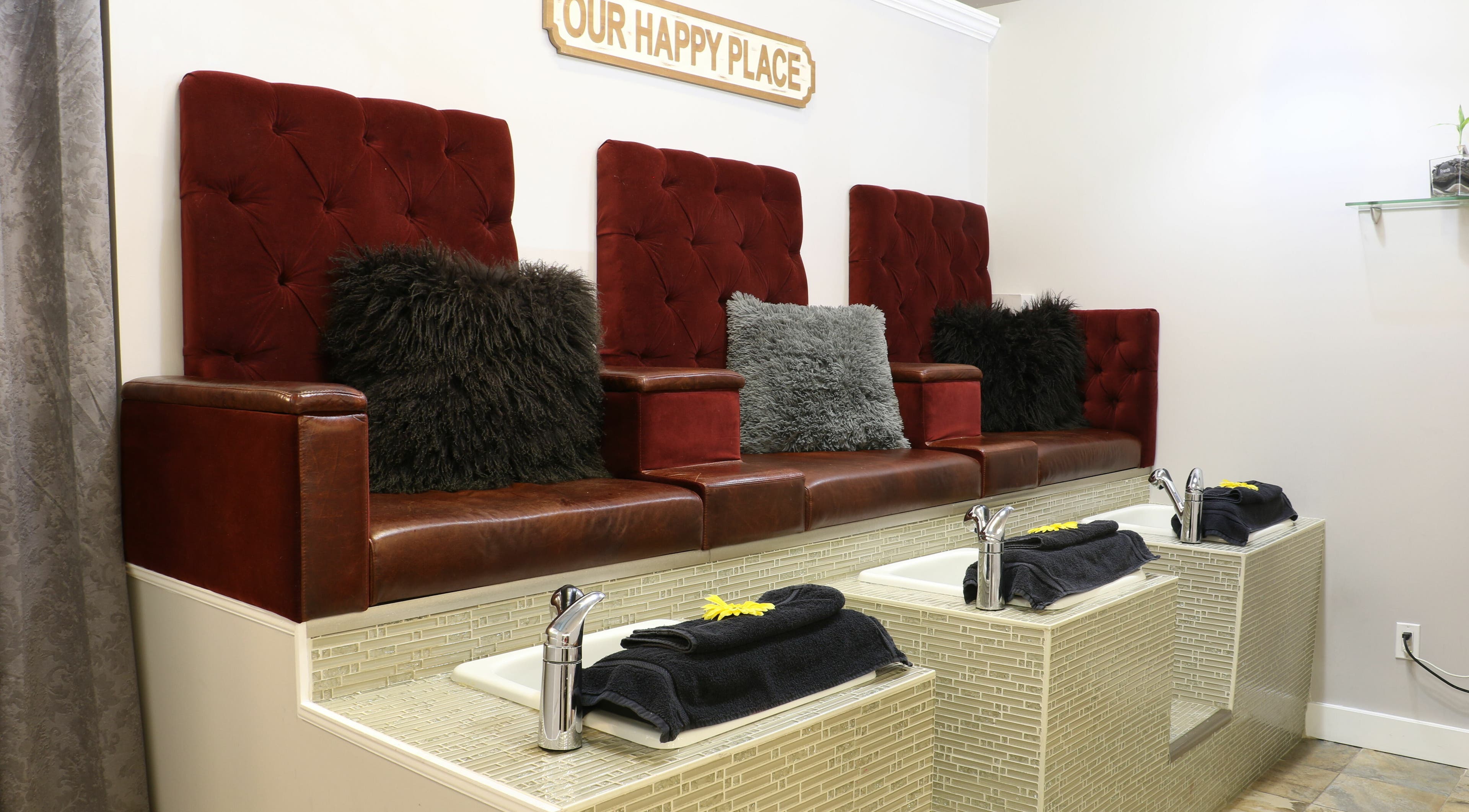 Luxurious pedicure seating at Boulevard Salon and Esthetics, Surrey, British Columbia, CA, with rich red upholstery.