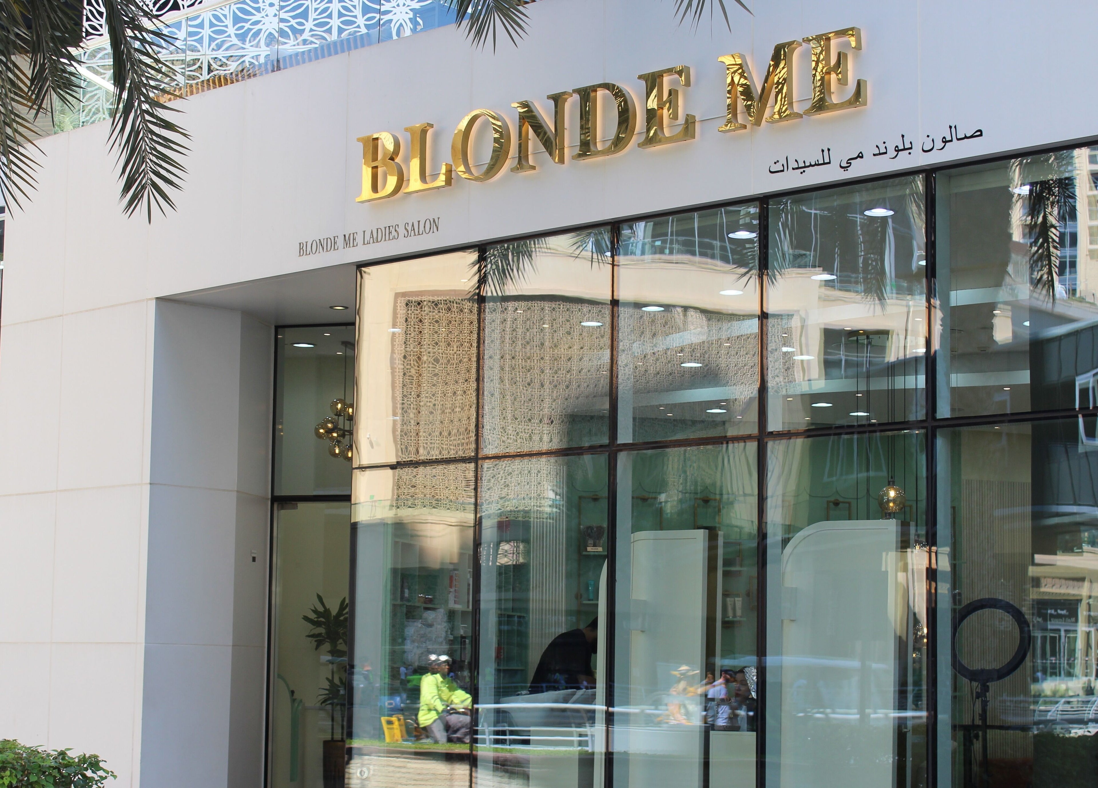 Blond Me Salon in Dubai, AE, features a stylish exterior with golden signage and glass entry.