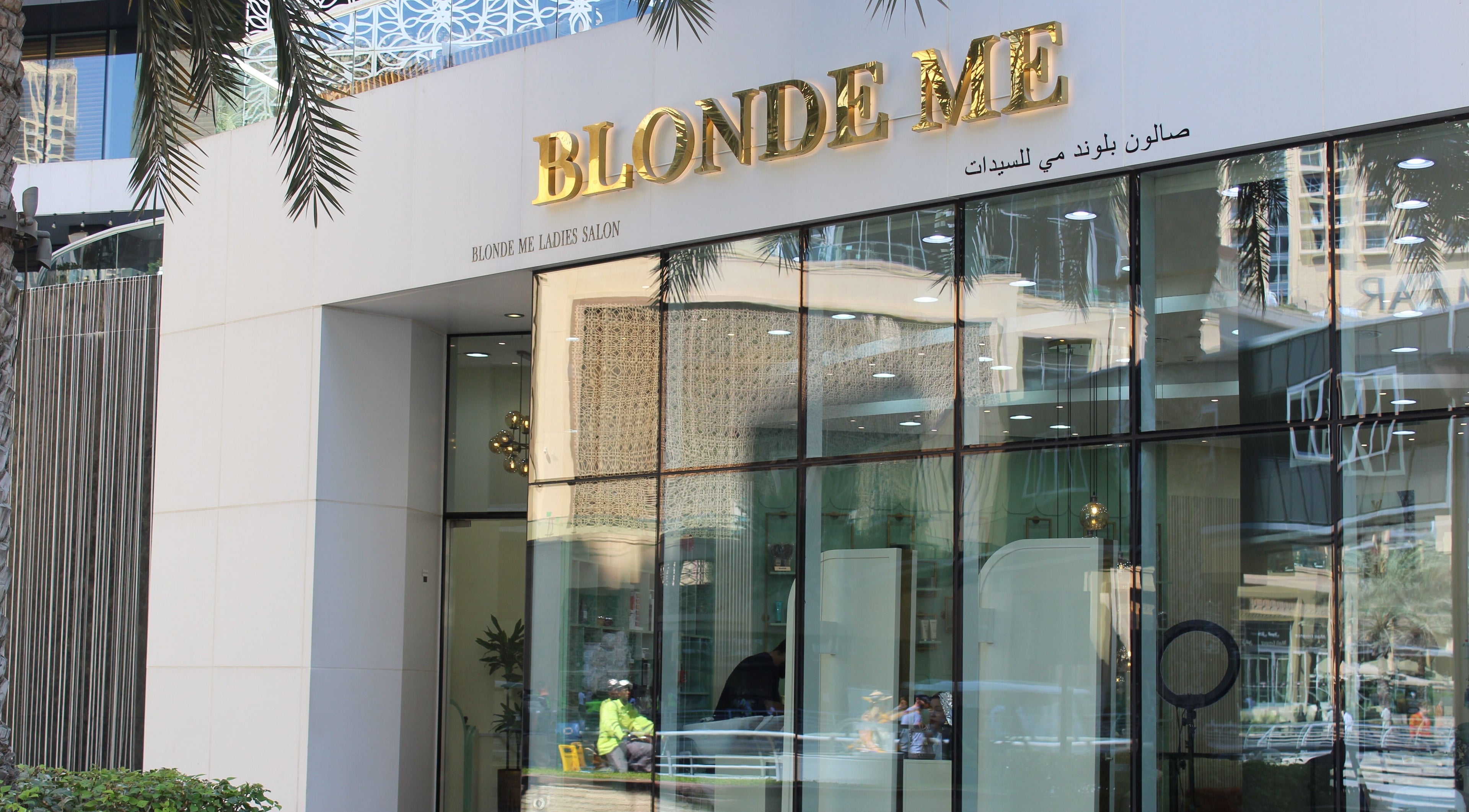 Blond Me Salon in Dubai, AE, features a stylish exterior with golden signage and glass entry.