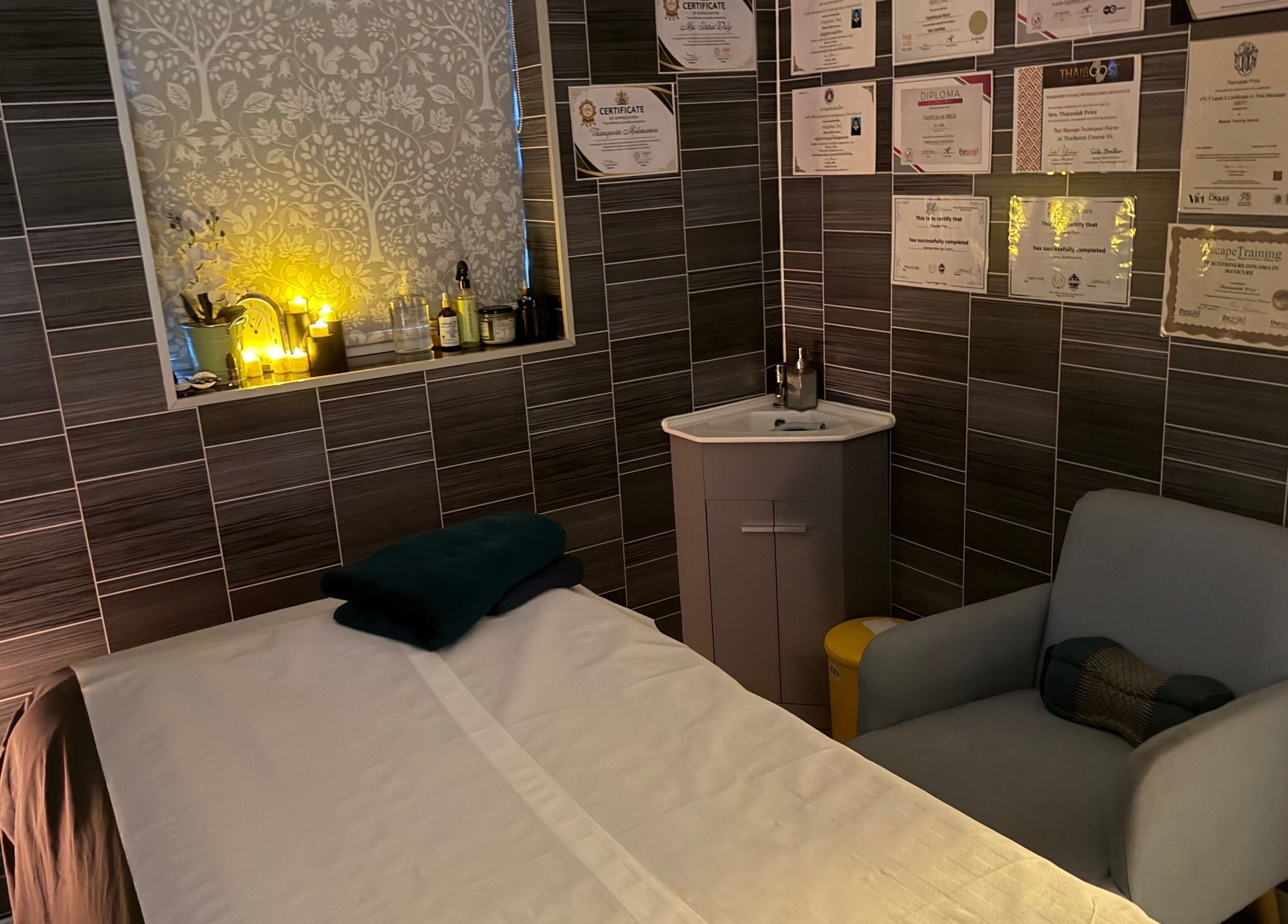 Massage room at Thai Spa & Clinic in March, England, GB, showcasing cozy ambiance and luxurious amenities.