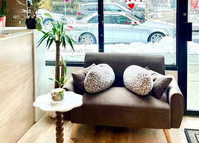 Inviting seating area at Giulia Love Salon in New York, New York, US with plush sofa and decorative plants.