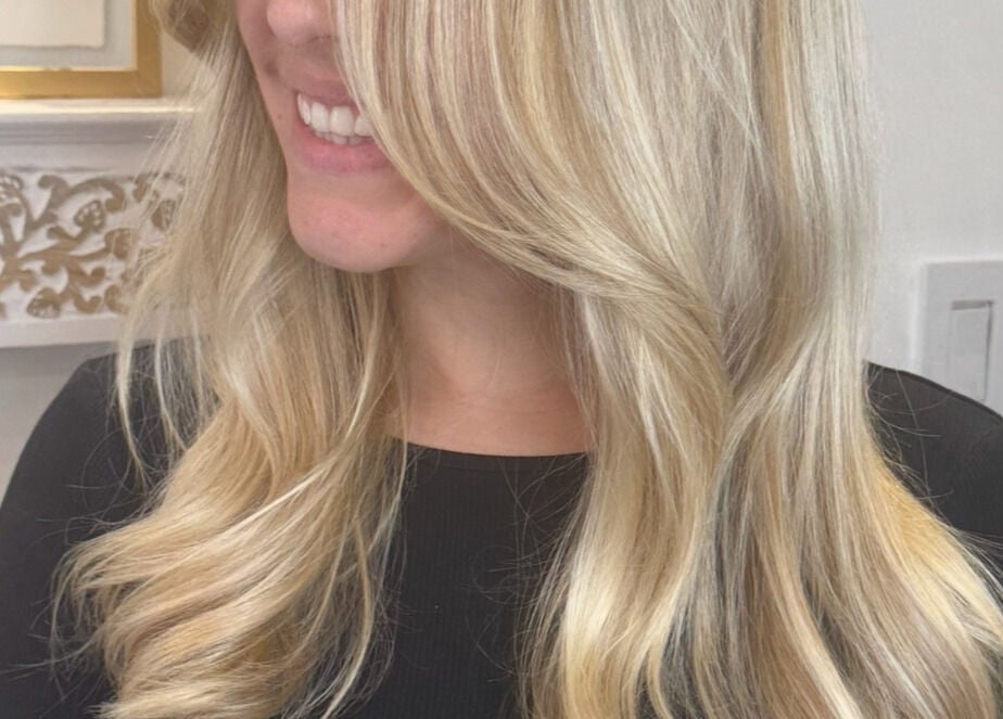 Blonde woman with wavy hair at Giulia Love Salon, New York, New York, US, showcasing styled elegance.