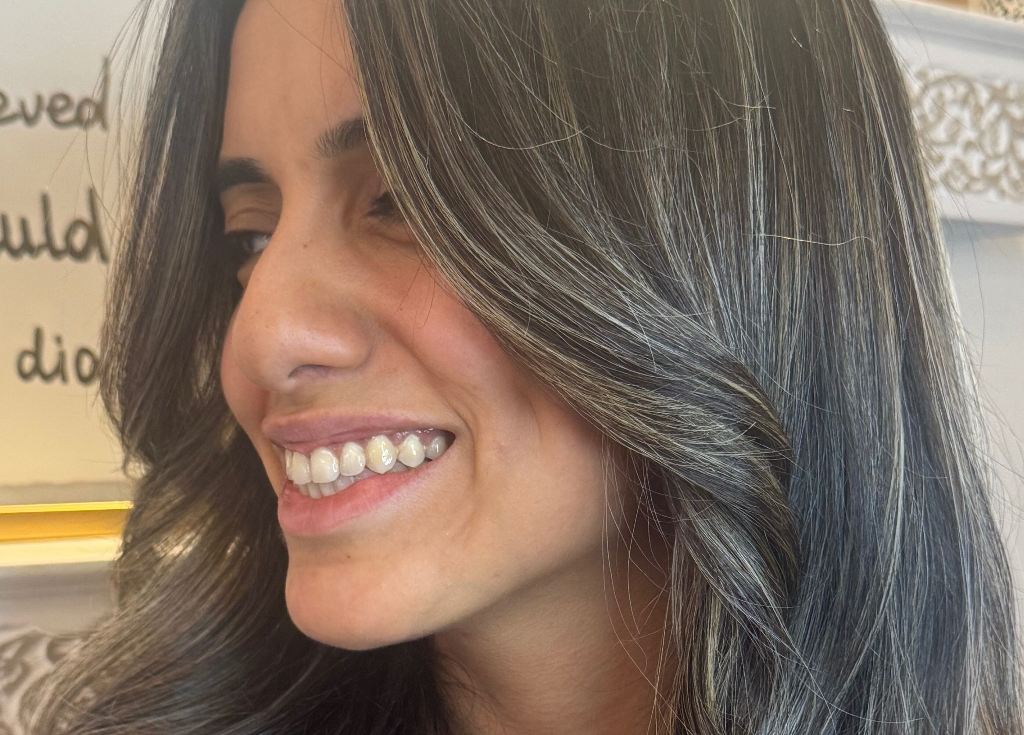 Smiling woman's styled hair at Giulia Love Salon, New York, New York, US.