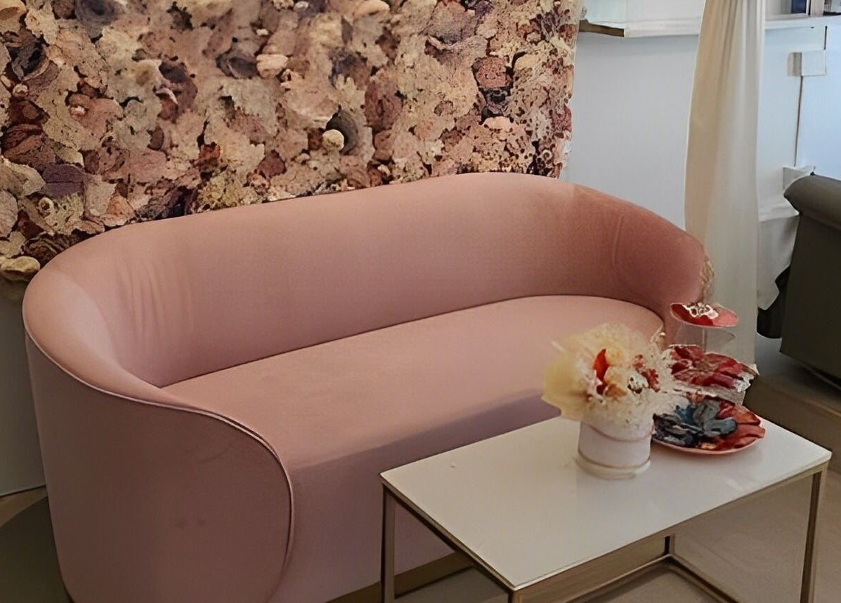 Chic pink sofa with textured wall at Ciao Lashes, Singapore, Singapore, SG, creating a cozy, elegant atmosphere.