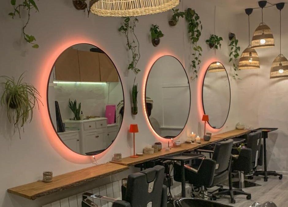 Stylish salon interior with backlit mirrors at Vivere Concept, Dublin 2, County Dublin, IE. Modern and inviting.
