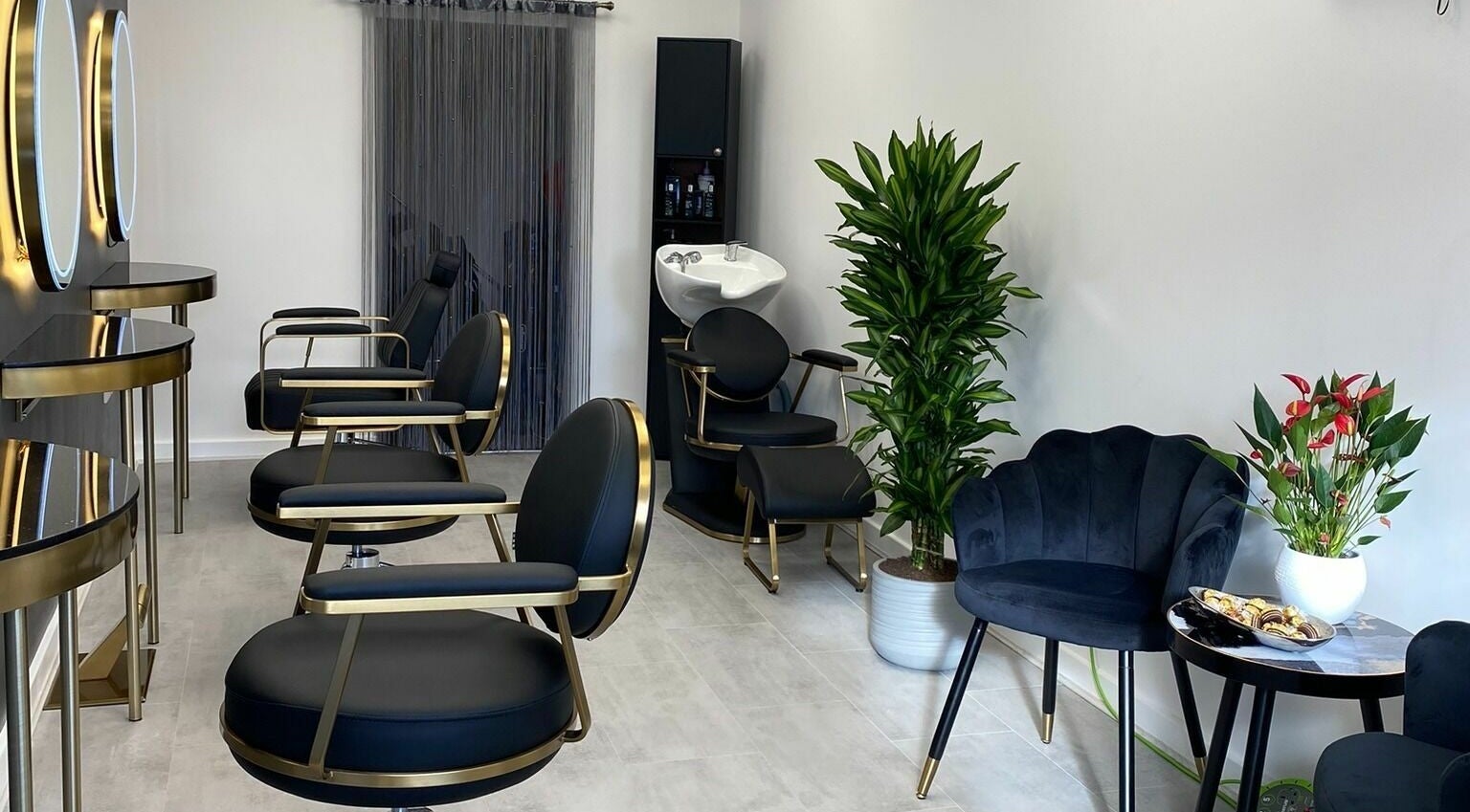 Stylish interior of Beauty Cuts Hairdressing in Poole, England, GB with chic chairs and decor.