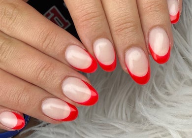 Red-tipped manicure at Nail House and Spa, Hollywood, Florida, US, showcasing elegant nail art design.