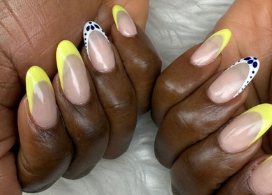 Close-up of stylish yellow and white nail art at Nail House and Spa, Hollywood, Florida, US.