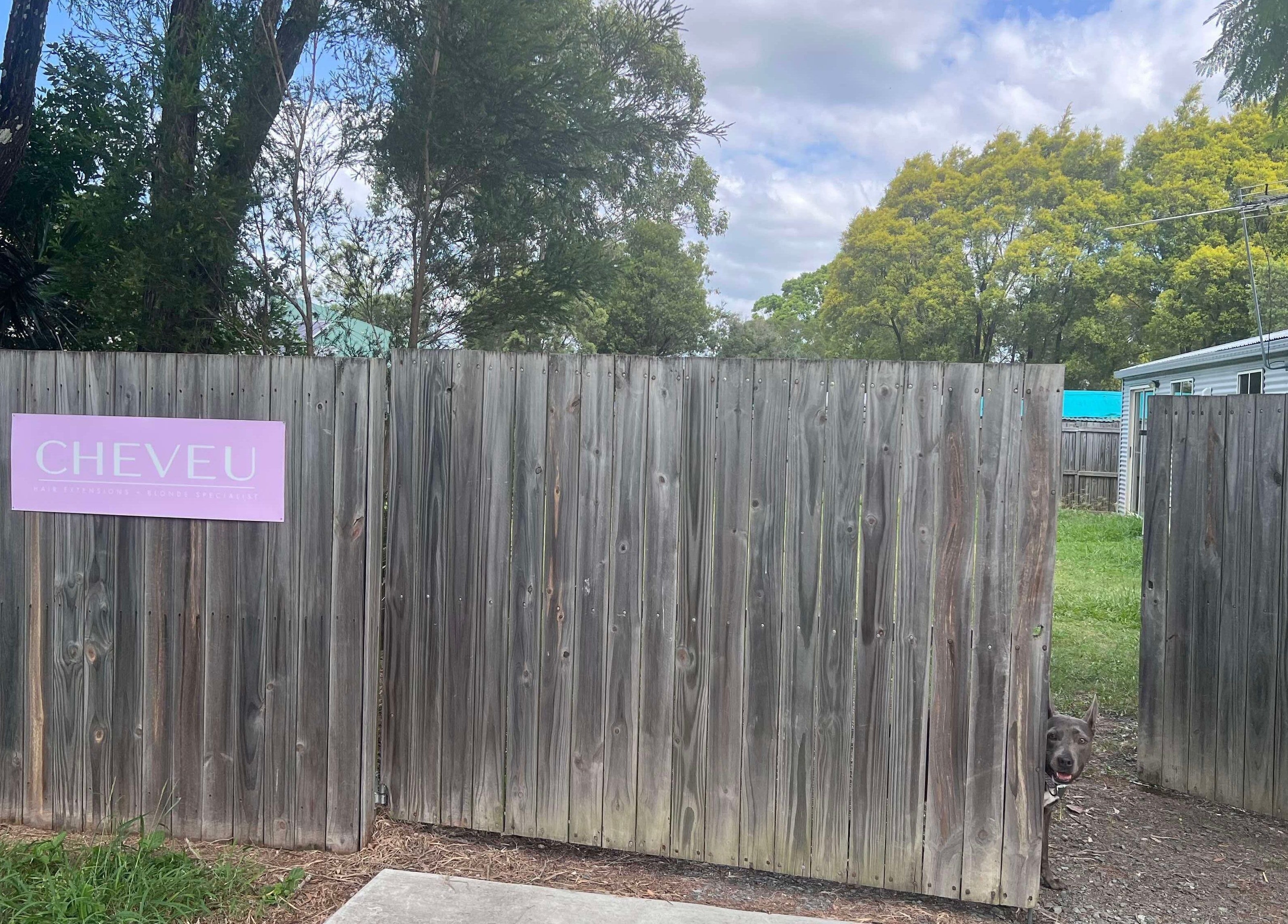 Entrance gate of CHEVEU in Jimboomba, Queensland, AU with a welcoming sign and greenery.