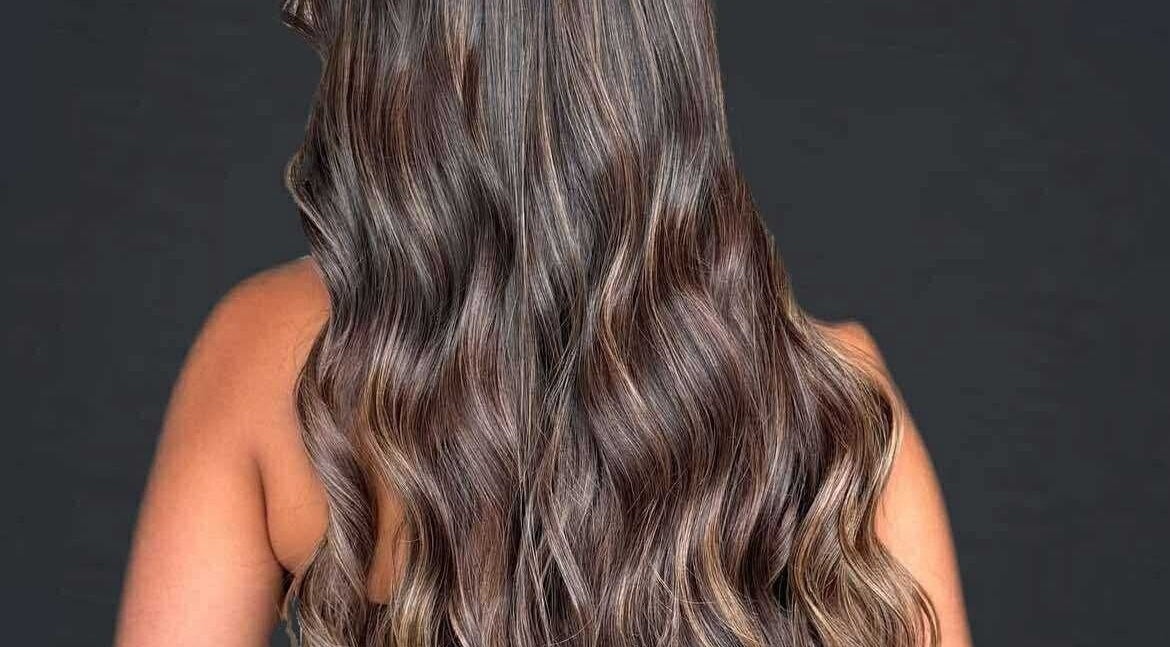 Elegant wavy hairstyle at CHEVEU in Jimboomba, Queensland, AU, showcasing rich brunette tones.