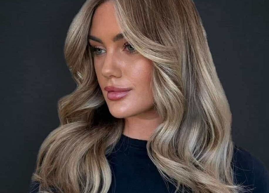 Stylish woman with wavy blonde hair at CHEVEU, Jimboomba, Queensland, AU.