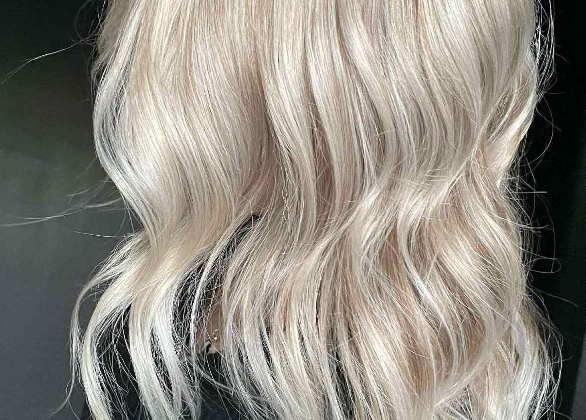Elegant platinum blonde waves styled at CHEVEU, Jimboomba, Queensland, AU, showcasing expert hair craftsmanship.