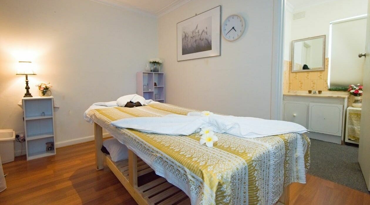 Serene massage room at Kornkanok Thai Massage in Melbourne, Victoria, AU with calming decor and soft lighting.