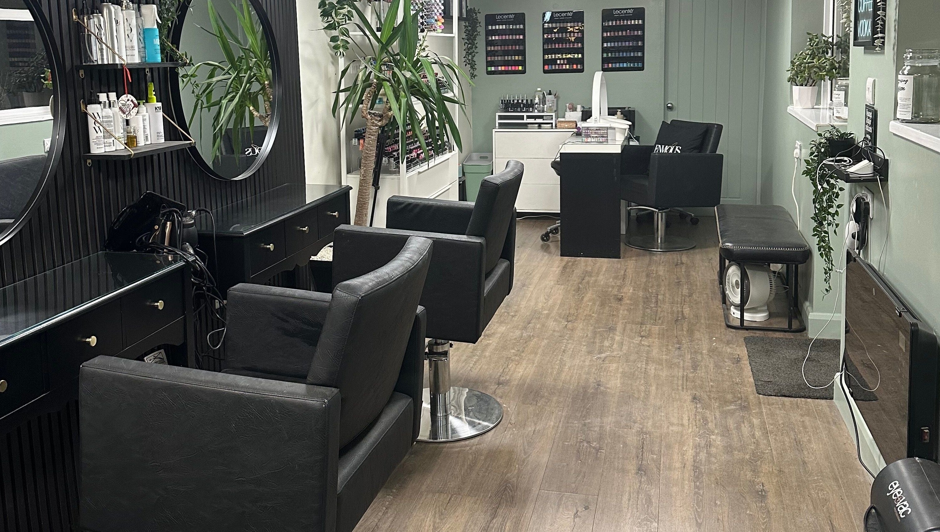 Modern interior of Envious Salon, Crawley, England, GB with elegant styling chairs and decor.