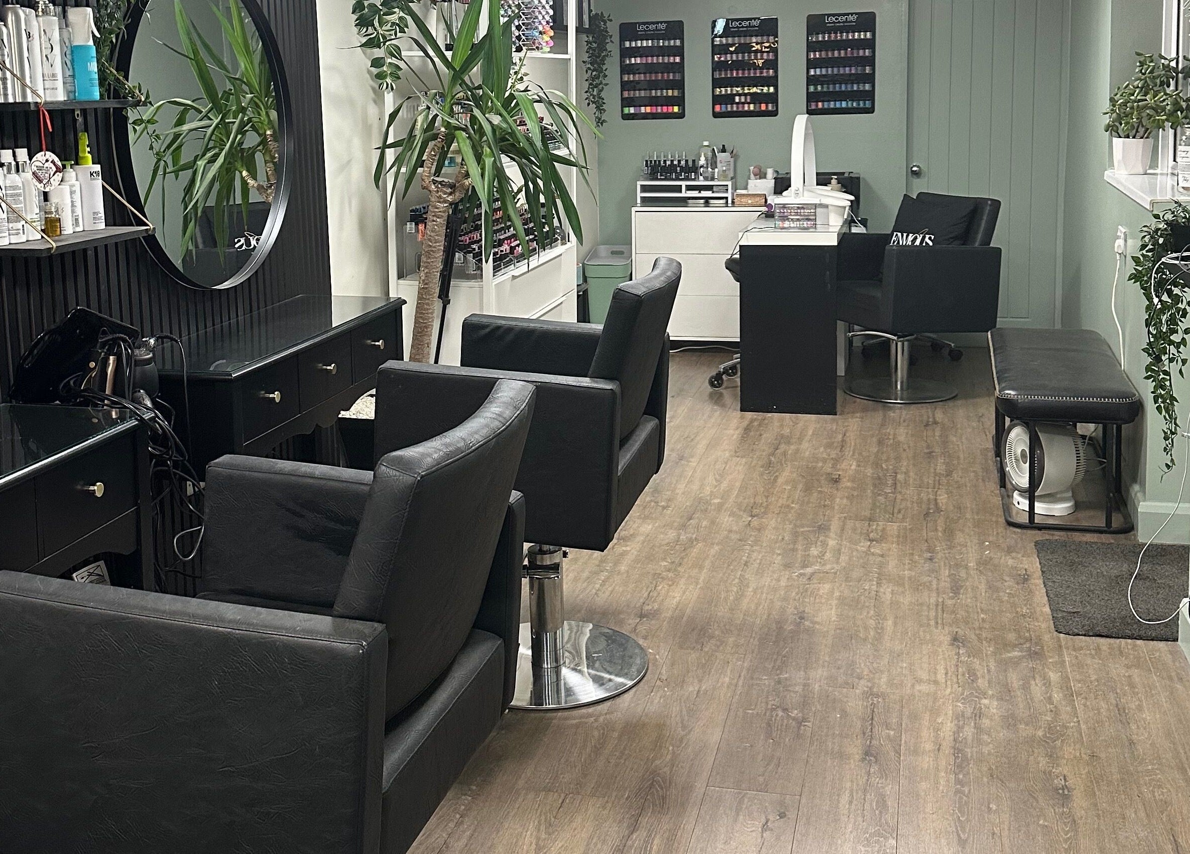 Modern interior of Envious Salon, Crawley, England, GB with elegant styling chairs and decor.