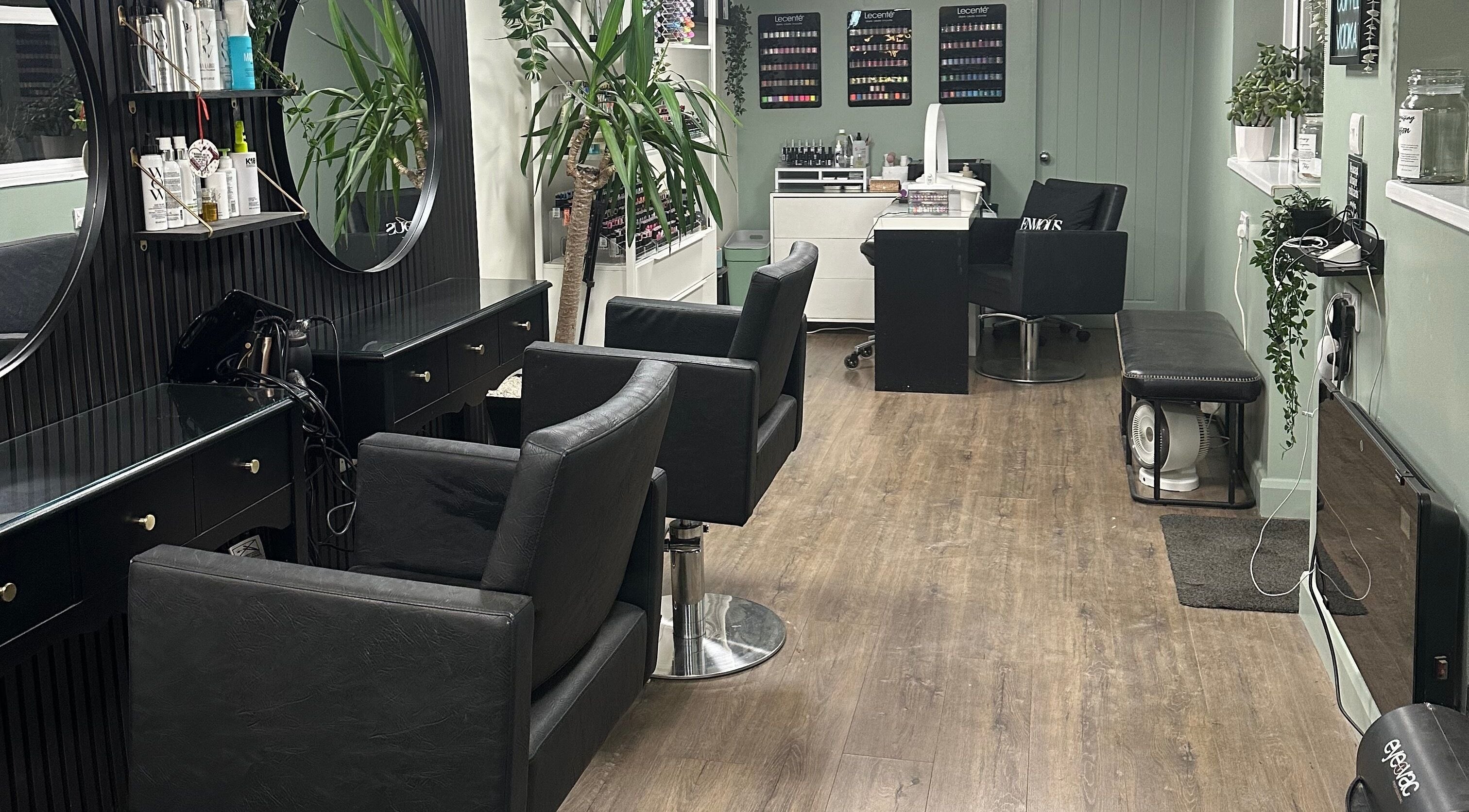 Modern interior of Envious Salon, Crawley, England, GB with elegant styling chairs and decor.