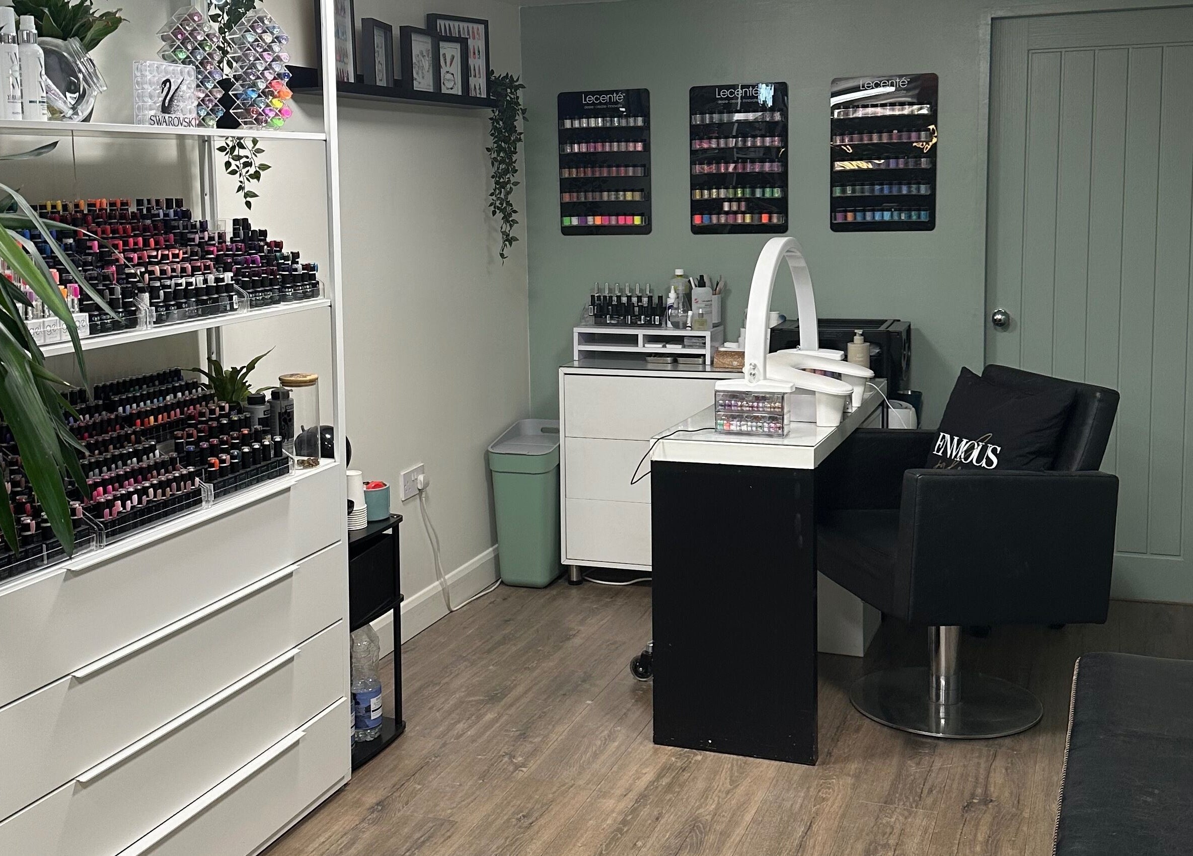 Chic nail bar at Envious Salon in Crawley, England, GB with a range of vibrant nail polishes on display.