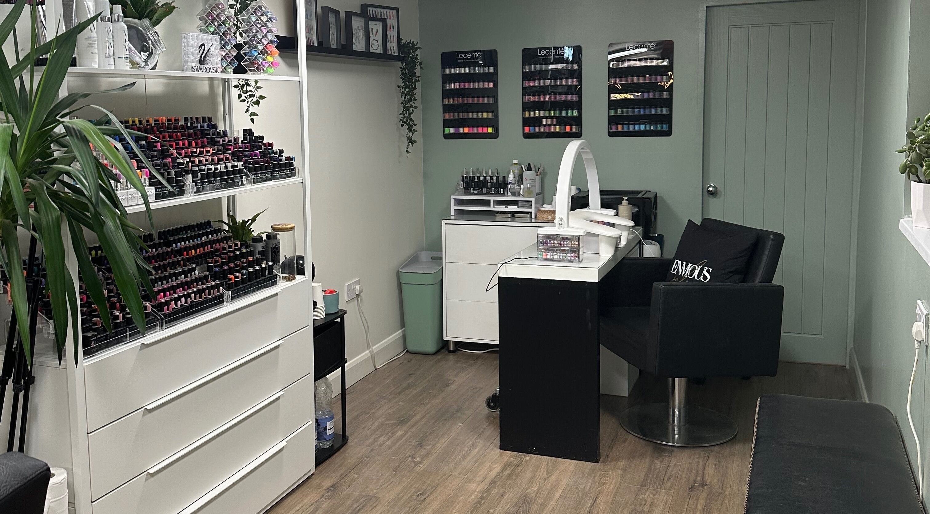 Chic nail bar at Envious Salon in Crawley, England, GB with a range of vibrant nail polishes on display.
