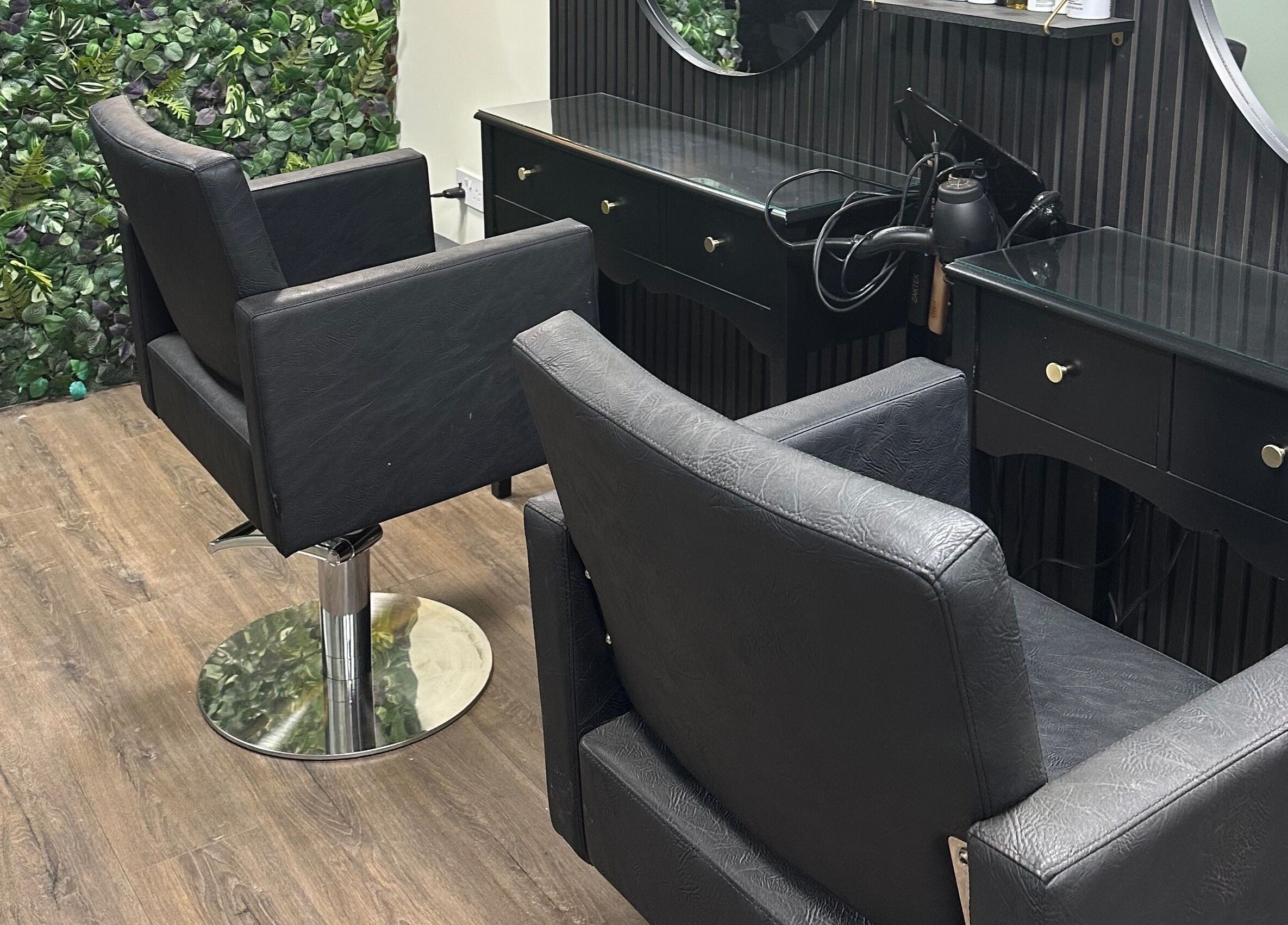Modern salon chairs and styling stations at Envious Salon, Crawley, England, GB create a chic ambiance.