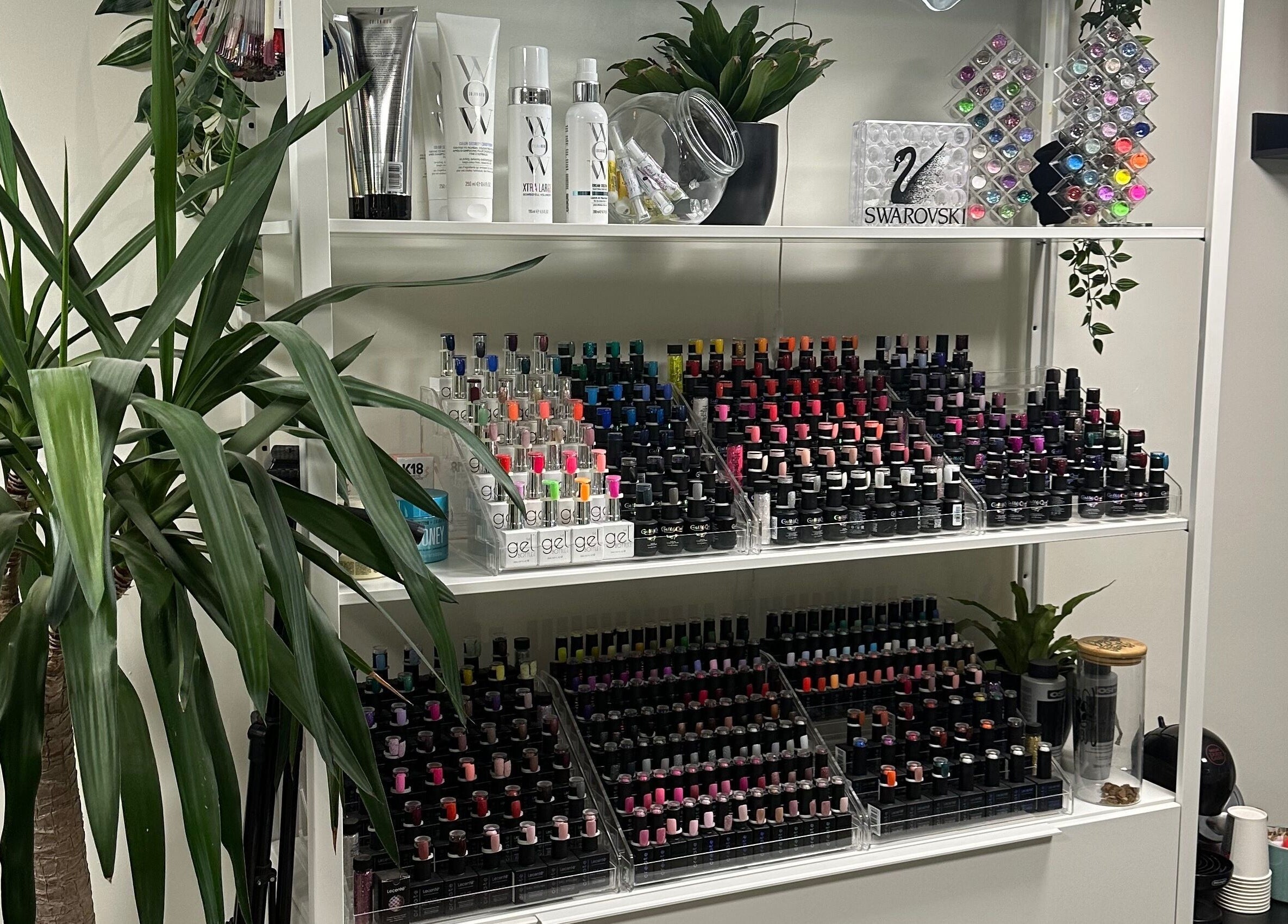 Colorful nail polish collection at Envious Salon, Crawley, England, GB, showcasing a wide range of choices.