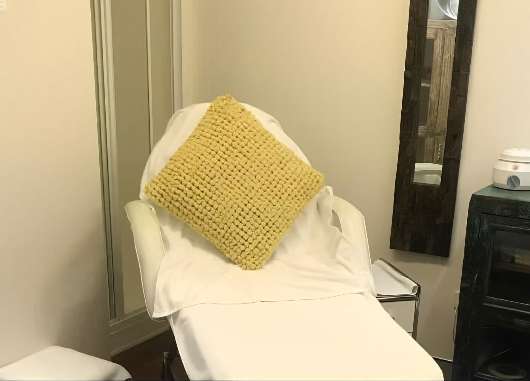 Relaxing treatment nook at Studio Vogue Salon, Baringa, Queensland, AU with a comfy chair and mirror.