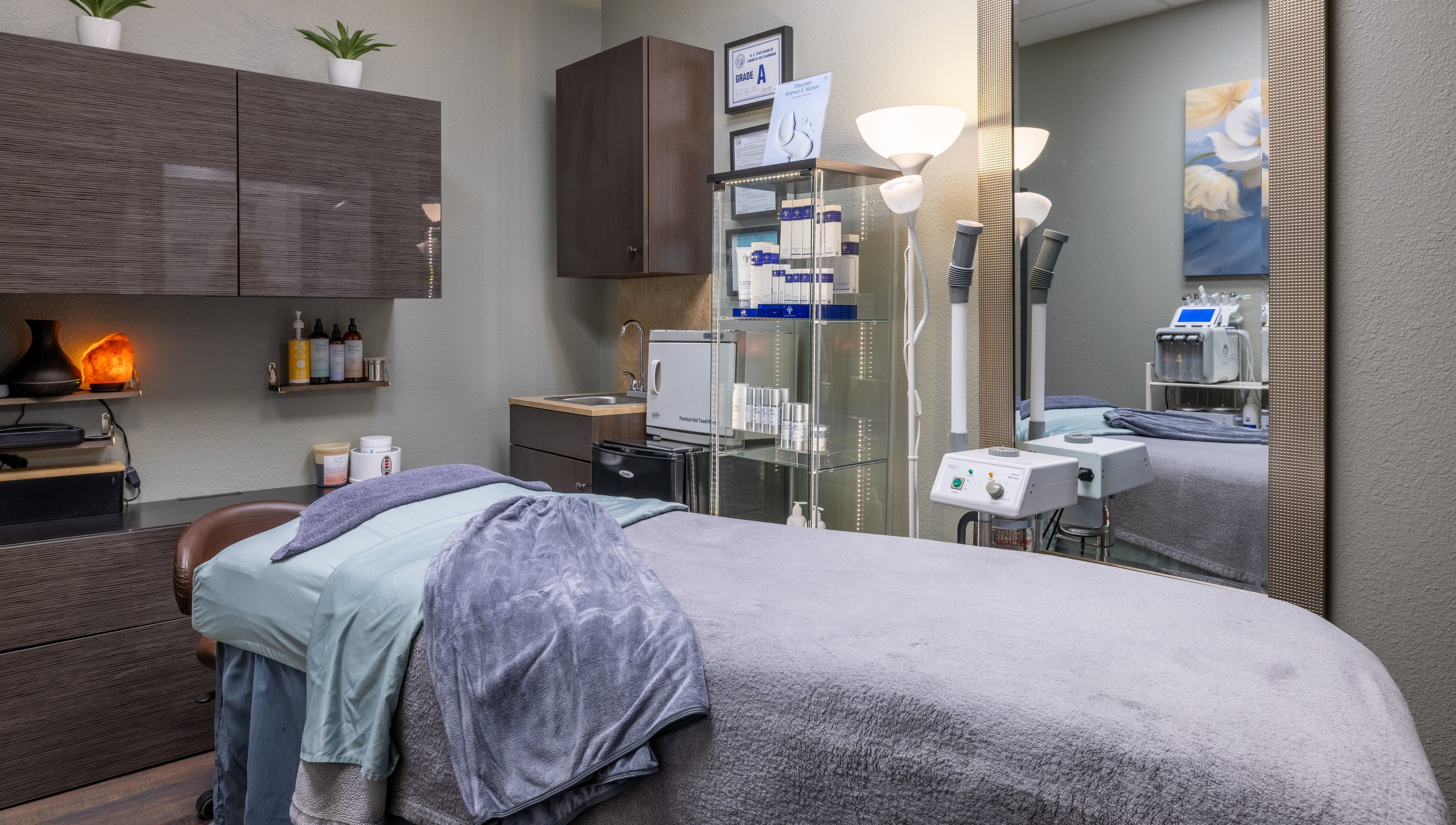 Cozy treatment room at Sweet Serenity Spa in Charlotte, North Carolina, US, featuring relaxation bed and equipment.