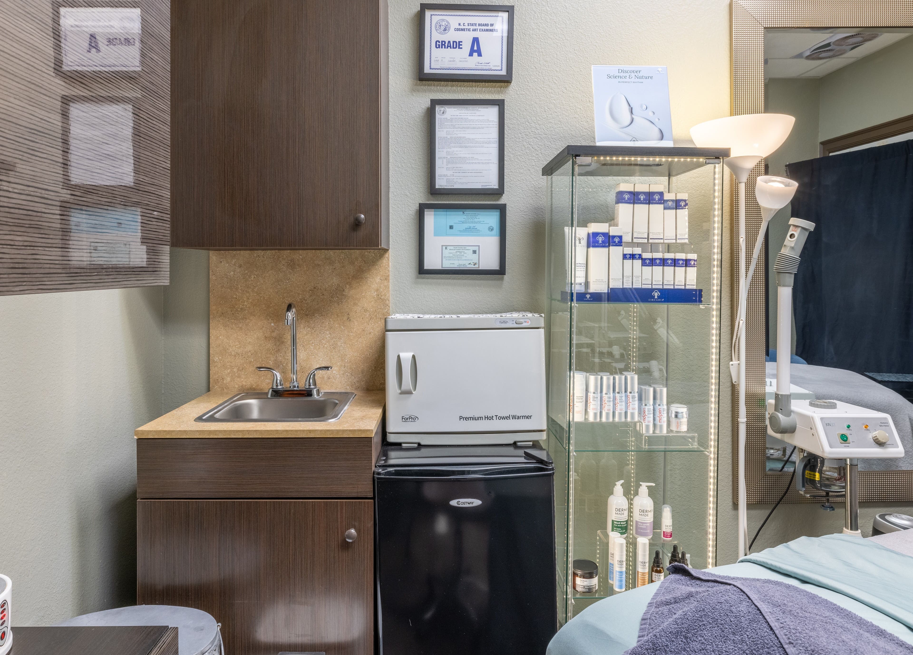 Tidy treatment room at Sweet Serenity Spa in Charlotte, North Carolina, US featuring skincare products and equipment.