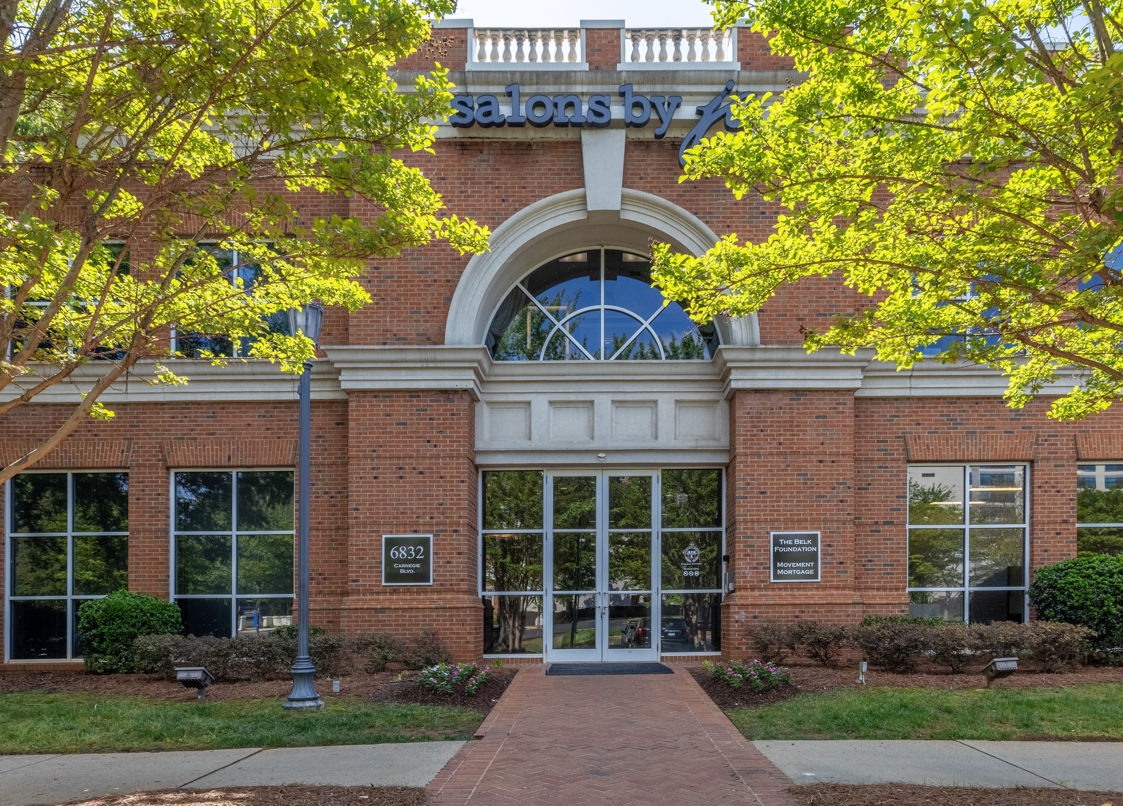 Sweet Serenity Spa's welcoming front entrance in Charlotte, North Carolina, US, with lush greenery.