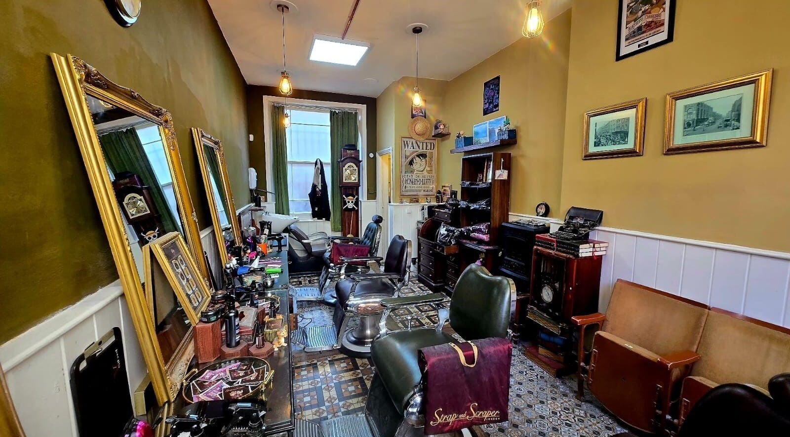 Interior of Strap and Scraper London Barbershop with vintage decor and barber chairs, London, GB.
