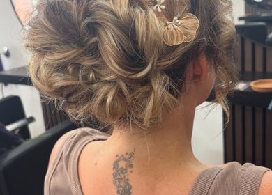 Intricate updo at Hair By Shannyn at Salon Biba, Larbert, Scotland, GB, featuring floral hair accessory.