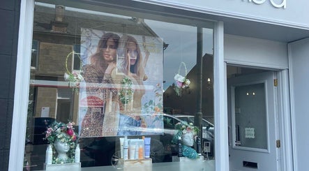 Elegant salon window display at Hair By Shannyn at Salon Biba, Larbert, Scotland, GB with beauty products showcased.