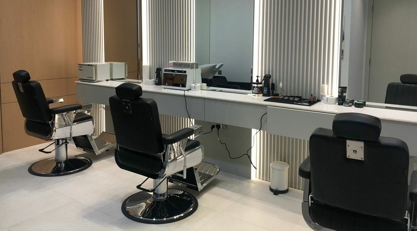 Modern barbershop chairs and elegant mirrors at Ok Gents Salon, دبي, دبي, AE.