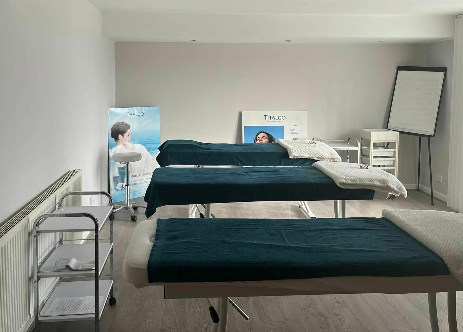 Calm treatment room at Lotus Spa and Academy Centre, Abbotskerswell, England, GB with massage tables.