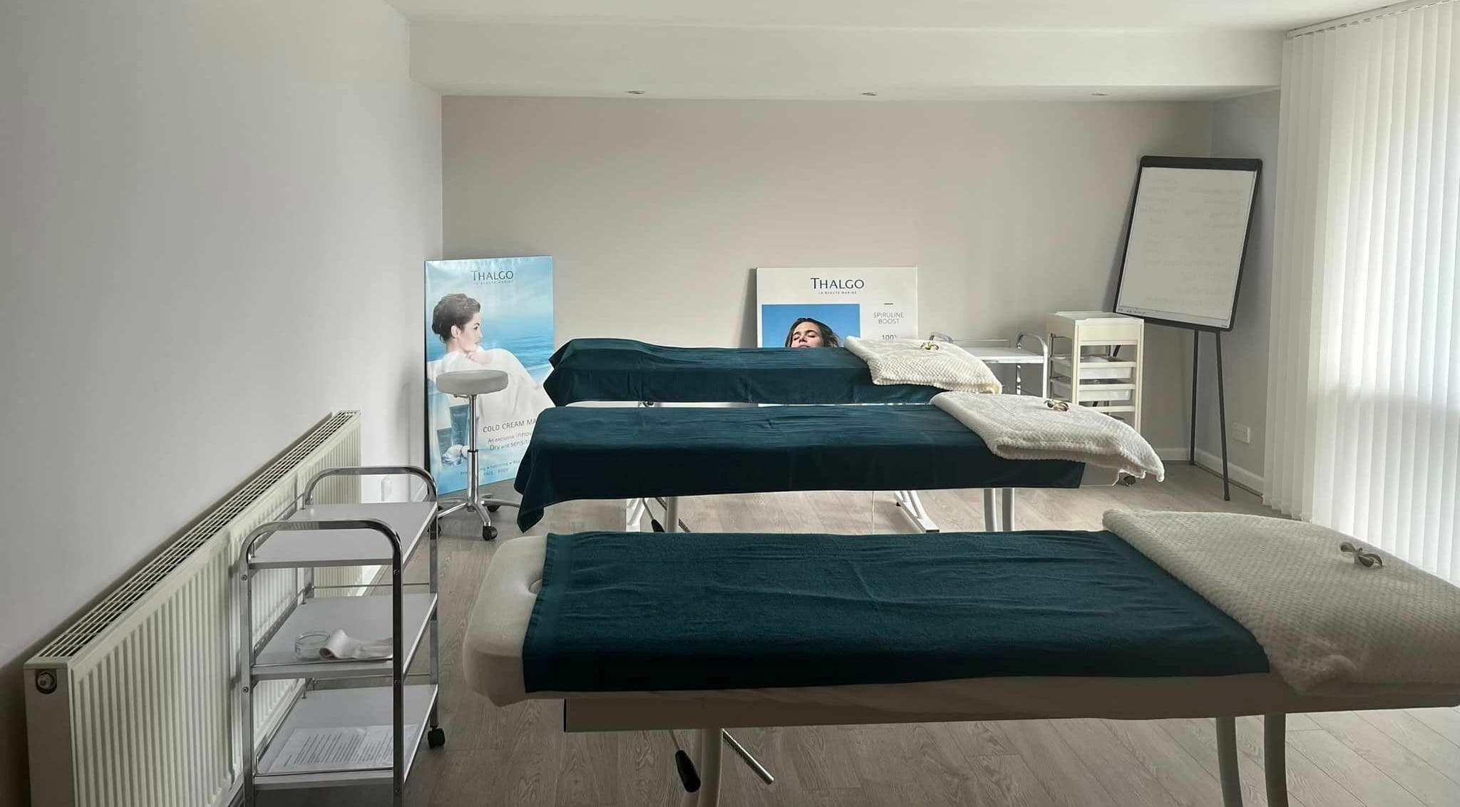 Calm treatment room at Lotus Spa and Academy Centre, Abbotskerswell, England, GB with massage tables.