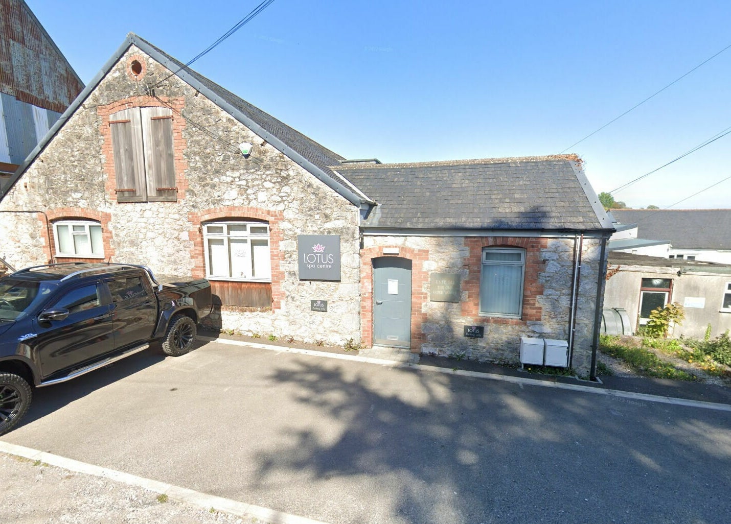 Exterior view of Lotus Spa and Academy Centre in Abbotskerswell, England, showcasing rustic stone design.